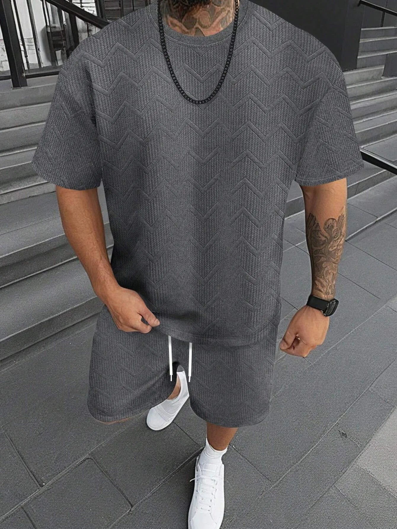Men's short sleeve top and shorts suit in a printed pattern, shown in a sport leisure style.