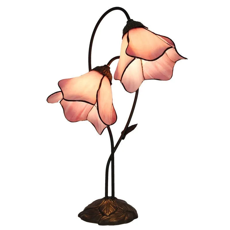 Retro American style table lamp with coloured glass lotus design shade on wooden surface