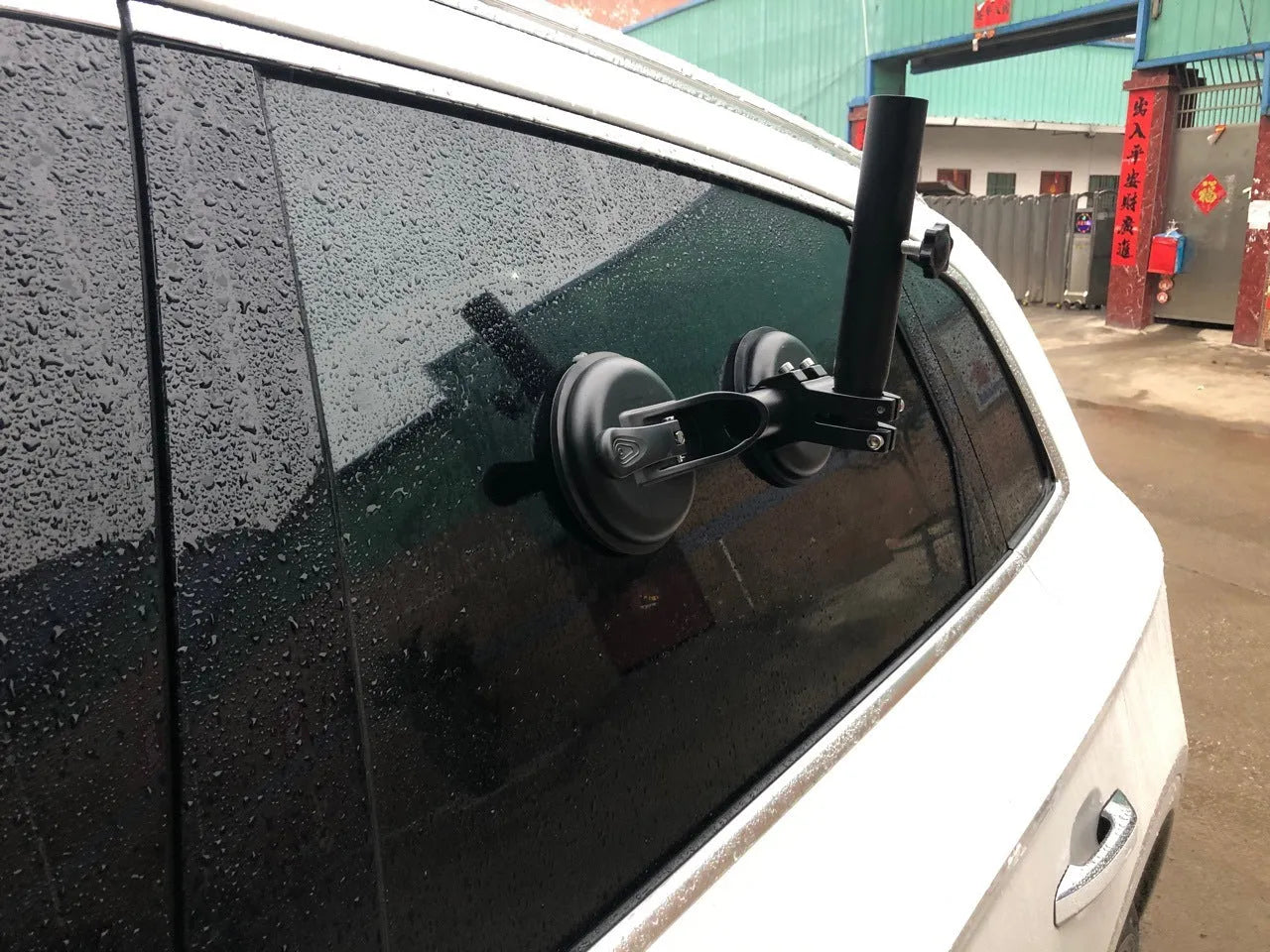 Black off-road car windscreen sucker mount with a large round rubber suction cup for flagpoles.