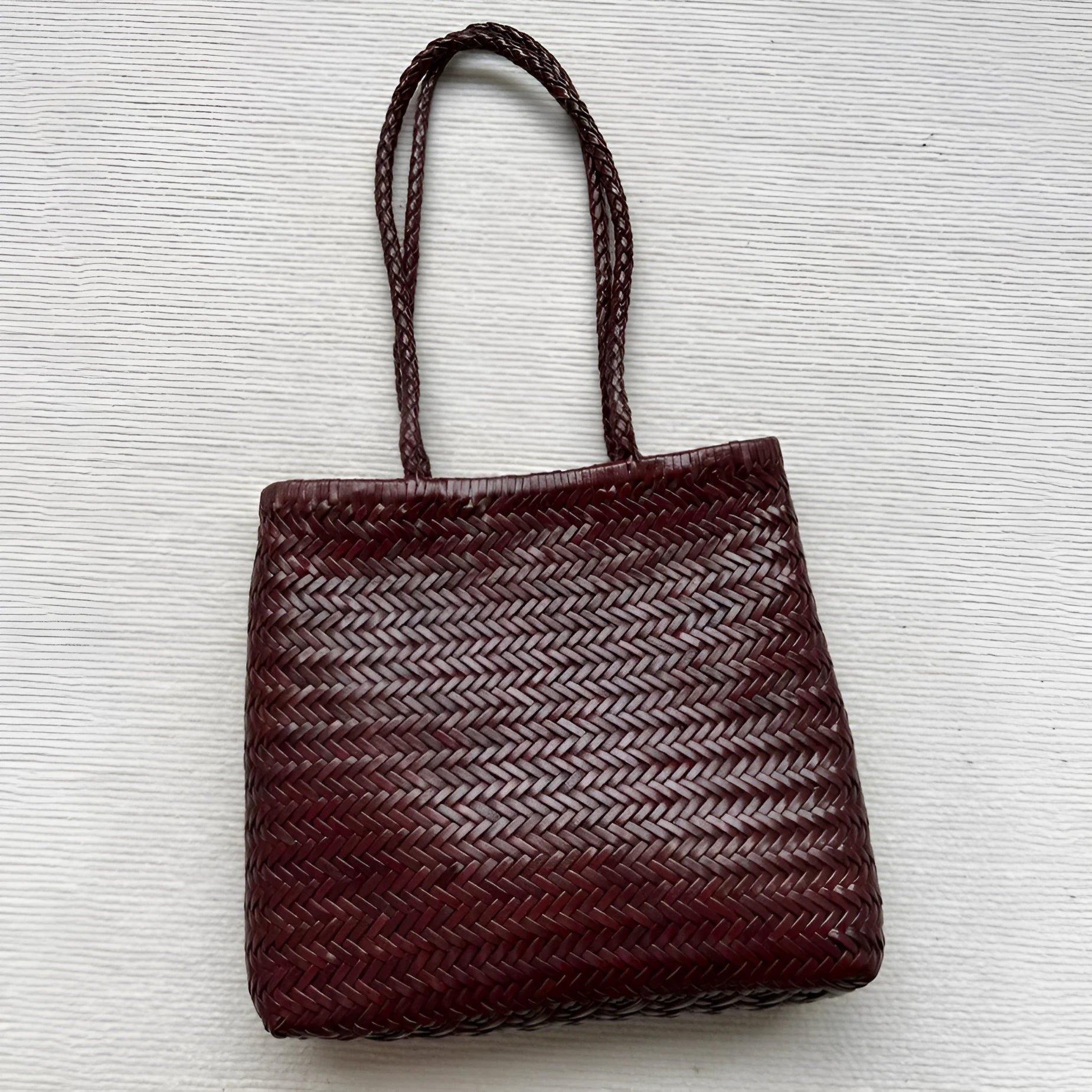 Brown woven genuine cowhide leather tote bag with a front pocket.
