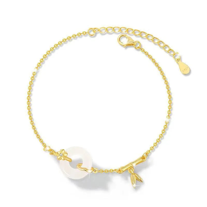 Women's silver bracelet with peace buckle clasp and white chalcedony gemstones in gold finish