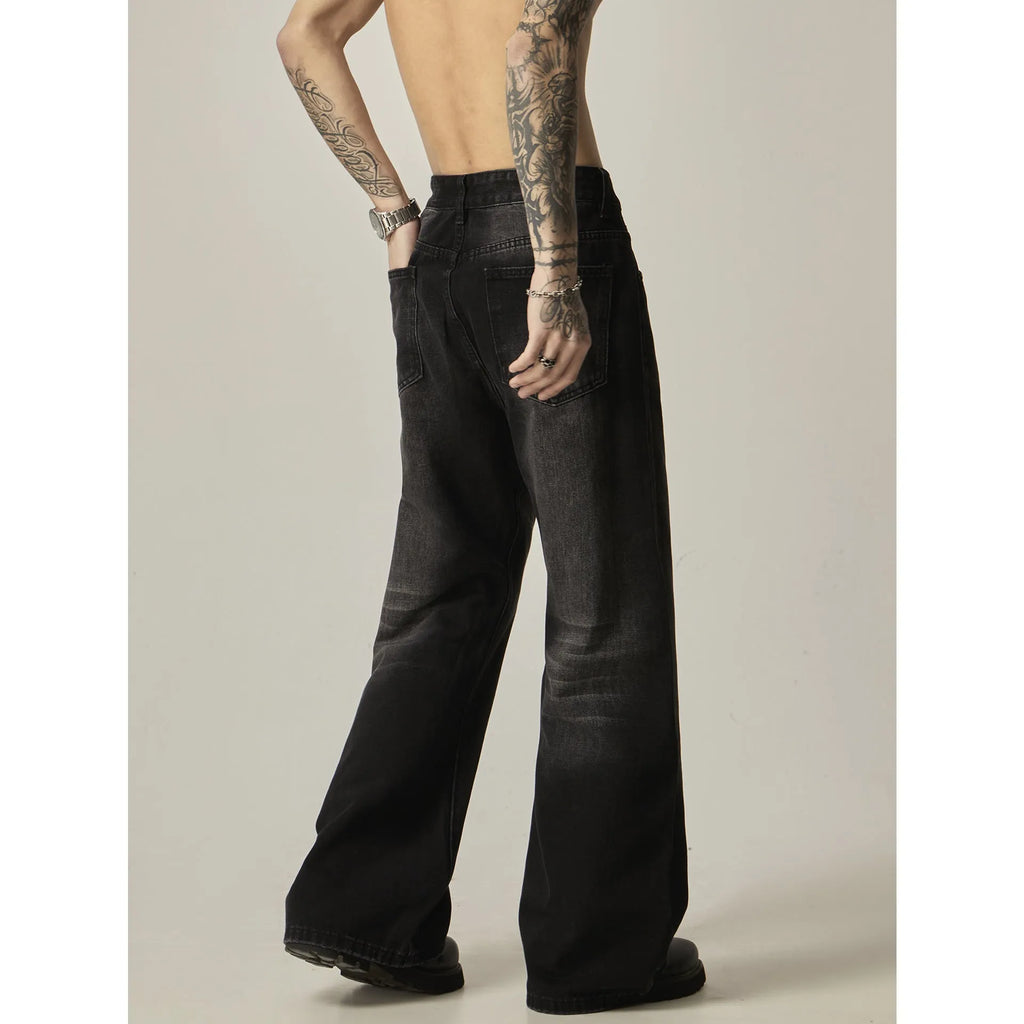 Black loose-fit straight-leg retro jeans with zipper fly on a plain background.