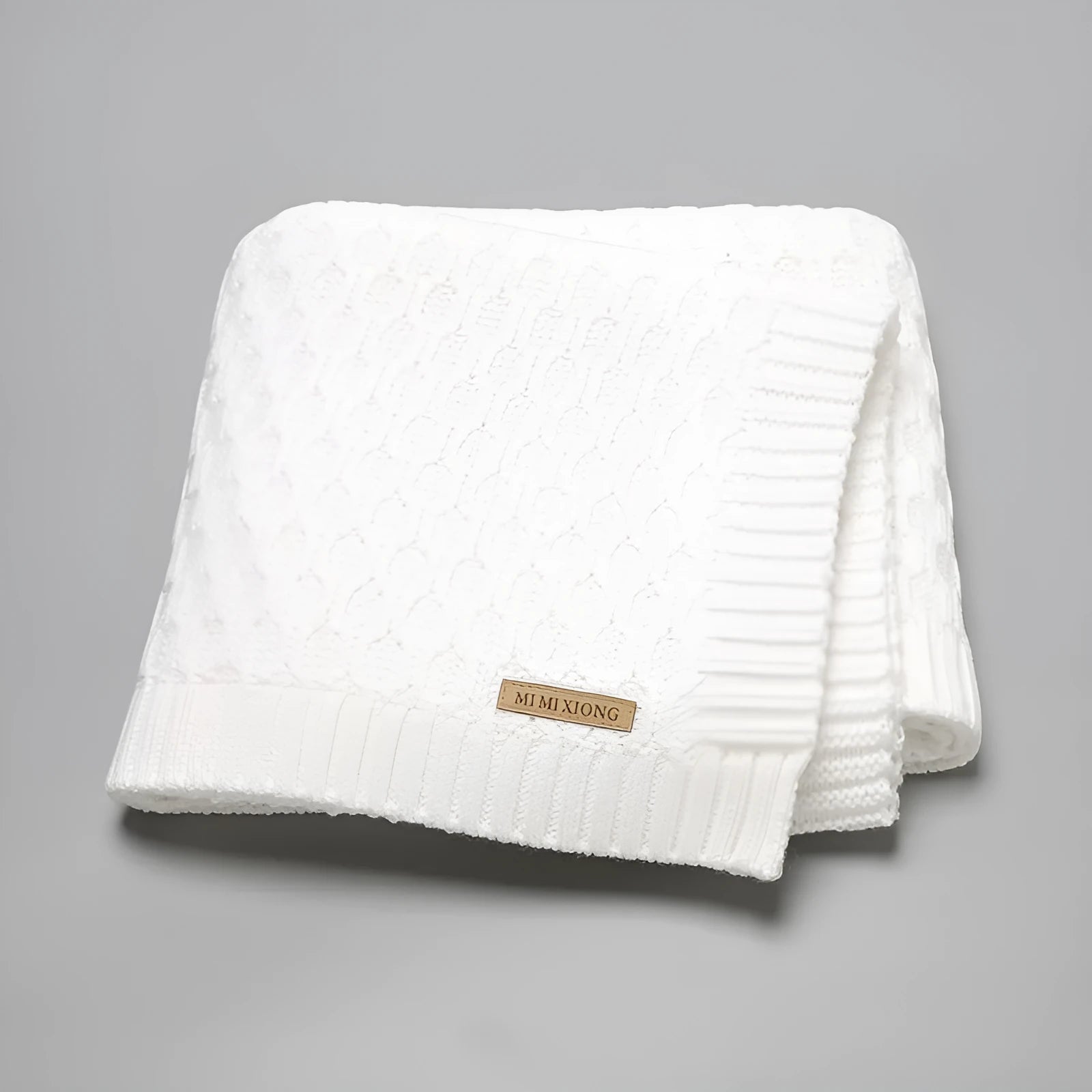 Solid colour baby hug blanket with raised line texture, shown in a light green colour.