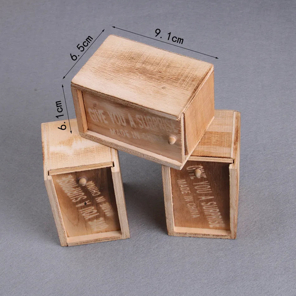 Wooden prank scare box measuring 9.1cm with a random jumping animal surprise inside