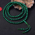 Handmade natural green agate 108 bead bracelet with thangka pendant on a wrist.