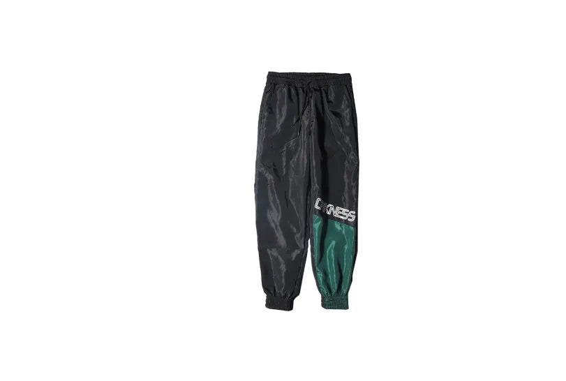 Green Japanese hip hop sweatpants with hit colour stitching, letter print, and bouquet floral design on a low-waist drawstring style