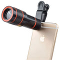 12X magnification phone telescope lens with attachment clip on a mobile phone.