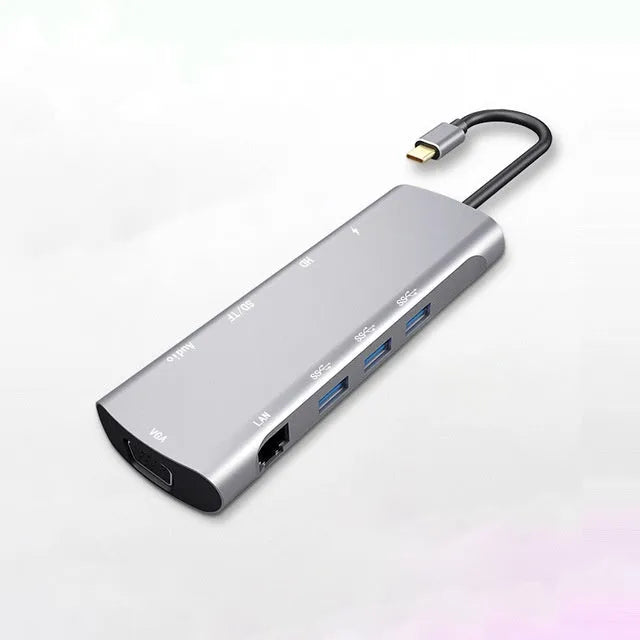 Grey aluminium alloy USB-C docking station with HDMI, VGA, USB ports, and a card reader.
