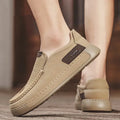 Men's breathable hollow leather slip-on casual shoes in black, side view
