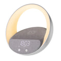 Beige and grey multifunctional wireless charging clock with Bluetooth speaker and LED light display.