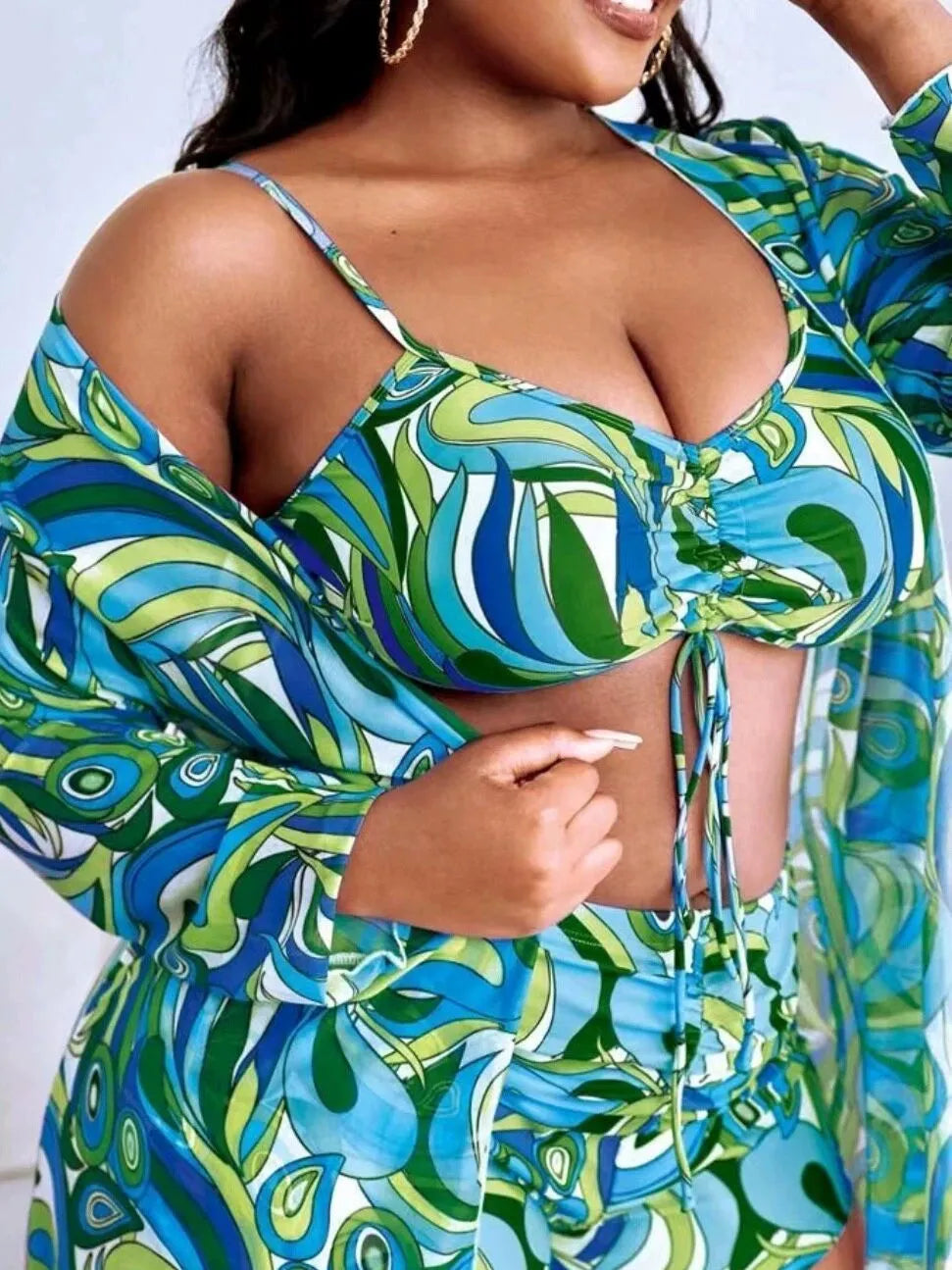 Women's floral print polyester bikini set with bra, briefs, and cardigan.