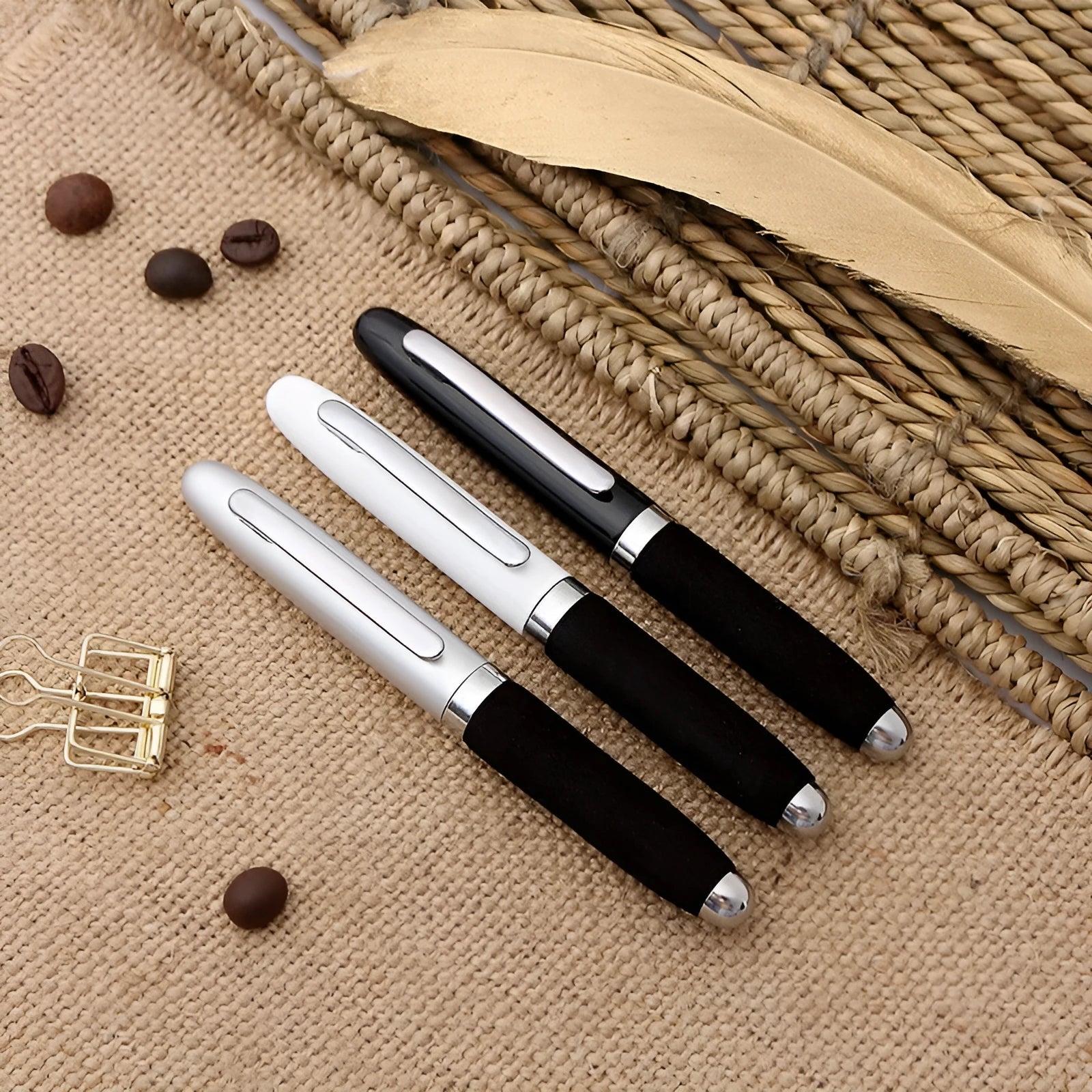Close-up of a silver EVA metal cap mini ballpoint pen with a 1.0 mm bullet tip, shown with a bright black refill.