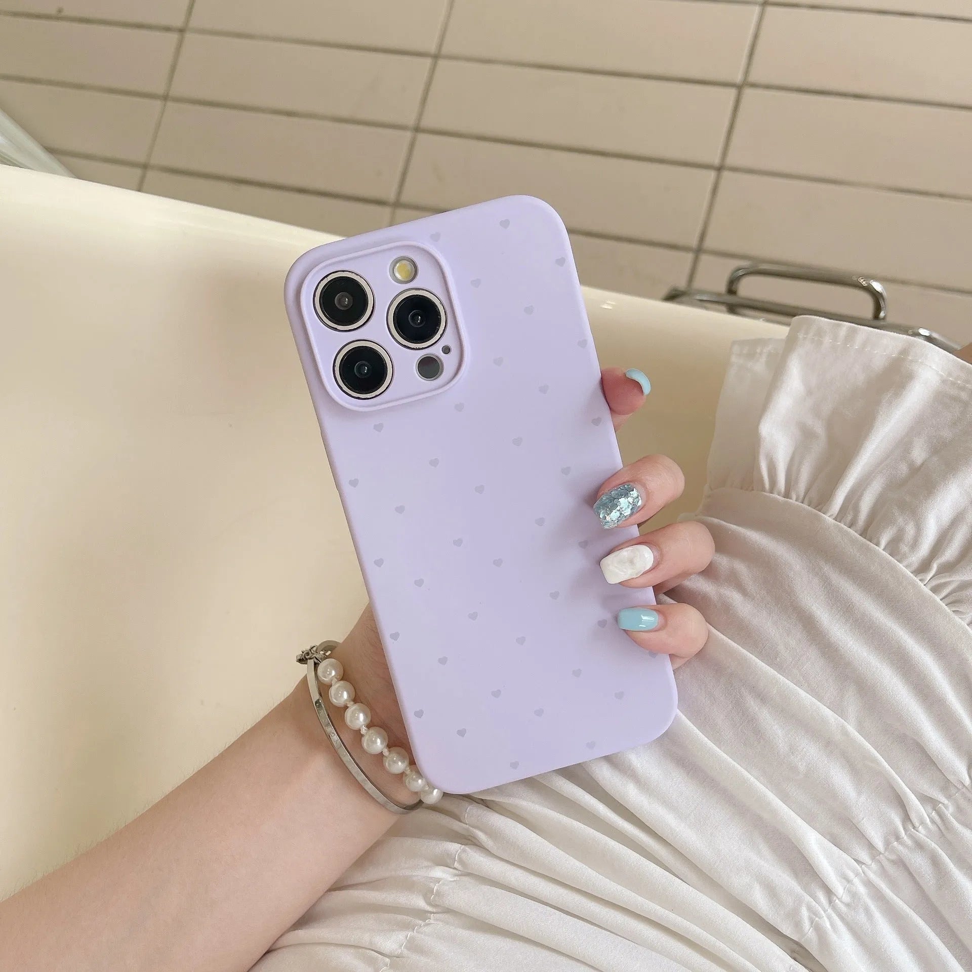 Liquid silicone phone case with love heart design in grass purple for iPhone 13, showing all-inclusive fit