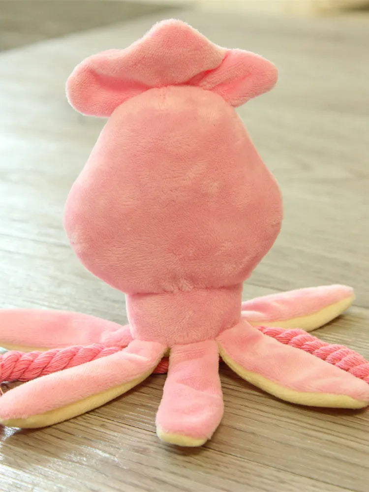 Pink octopus pet plush toy rope toy for dogs with soft fabric head and rope body on white background