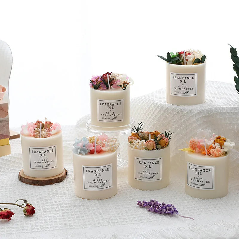 Dried flower decor scented candle in glass jar with botanical elements visible within wax