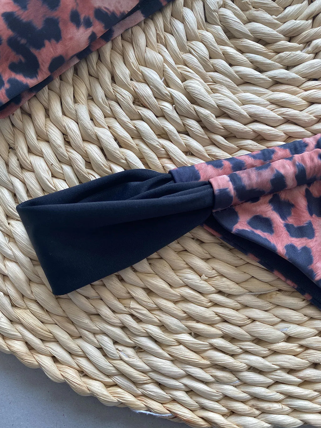 Women's leopard print bikini set with tube top and split bottoms in black and animal print
