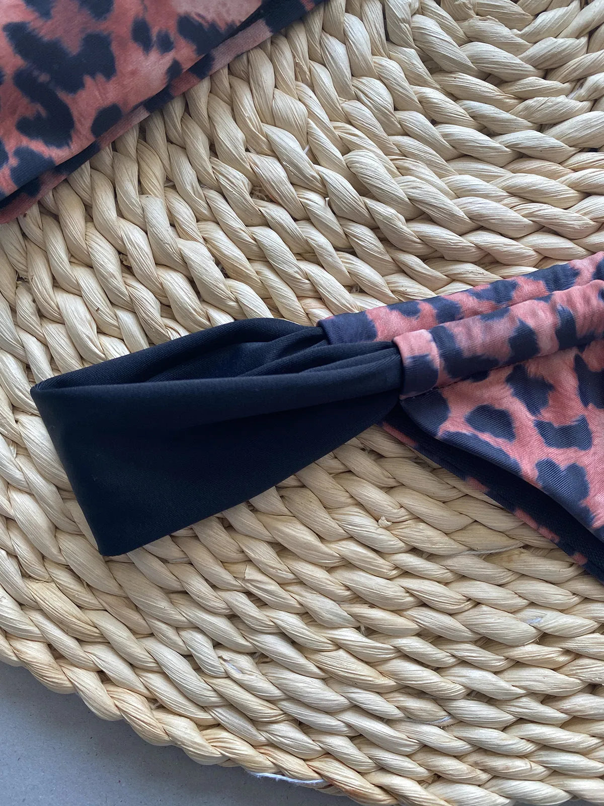 Women's leopard print bikini set with tube top and split bottoms in black and animal print