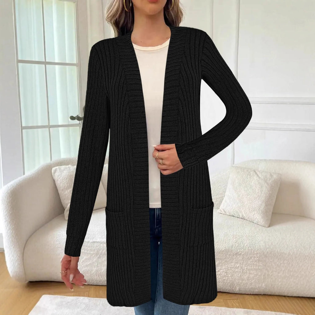 Long sleeve loose knitted cardigan jacket in black, shown with side pockets.