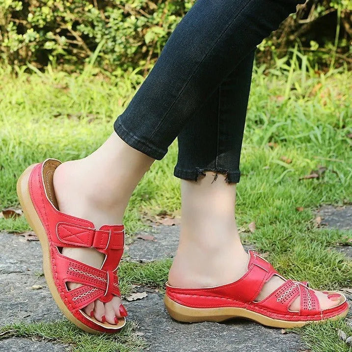 Women's black wedge sandals with a peep toe and Velcro fastening strap.
