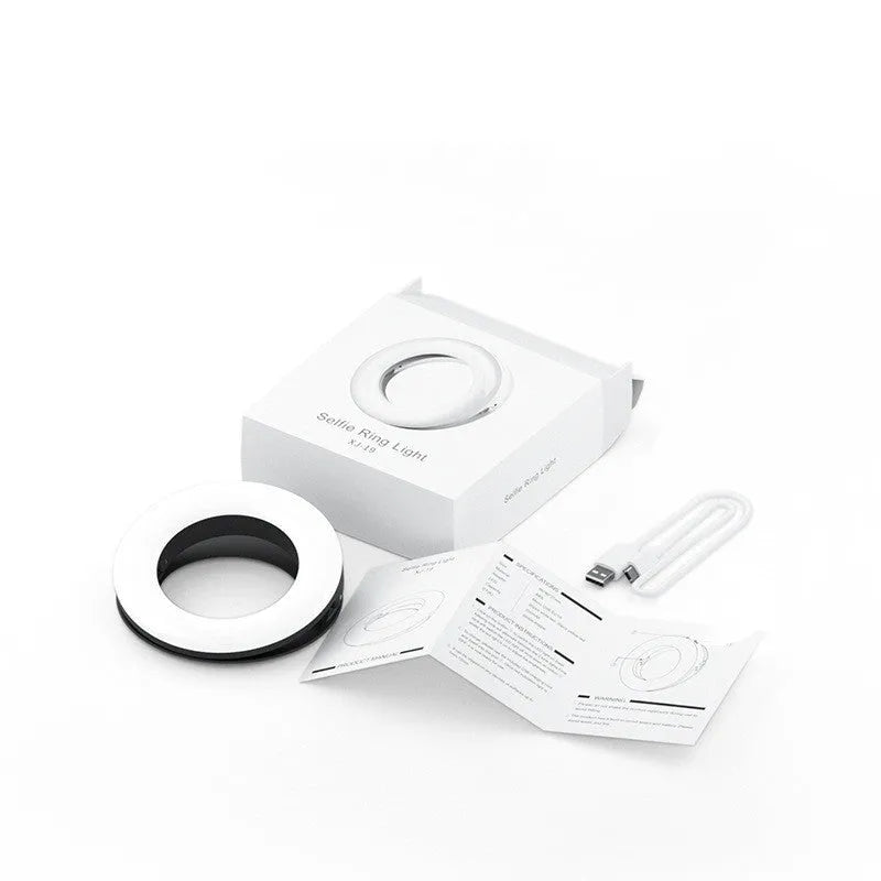 Compact black ring light for smartphone photography with USB charging cable.