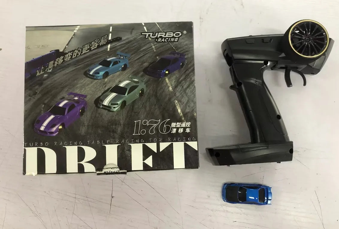 Blue and green Turbo Racing C64 remote control drift cars with handle-style remote controllers