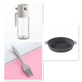 Warm grey glass oil spray bottle with dual-mode switch and automatic tilt-open lid