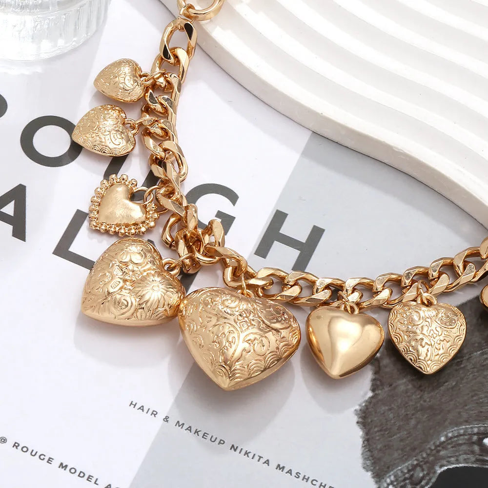 Gold carved heart pendant necklace on a metal chain, adjustable from 41cm to 50cm.