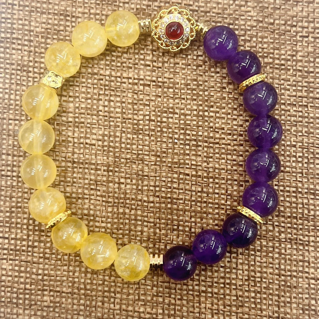 Handmade women's yellow and purple amethyst crystal bracelet showing manual craftsmanship detail