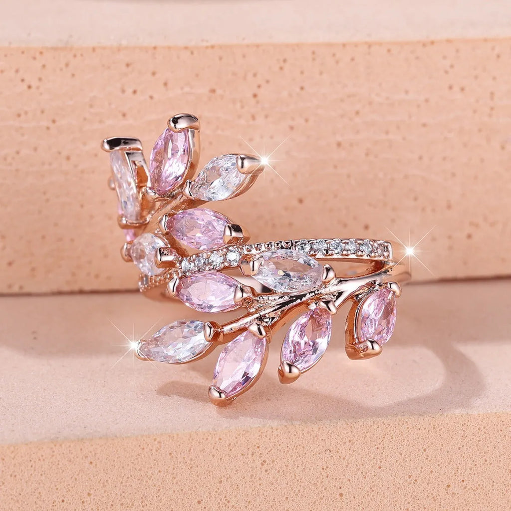 Adjustable copper leaf-shaped ring with a Horse Eye Zircon stone, shown in a rose gold finish.