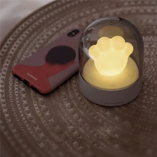 Grey or pink cat paw shaped USB rechargeable night light with rotating soft light and music box feature