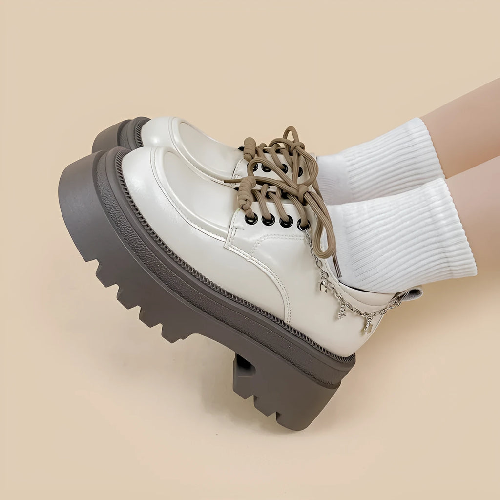 White platform Mary Jane shoes with chunky heel and lace-up front