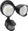 White outdoor LED security flood light with motion sensor mounted on a wall.