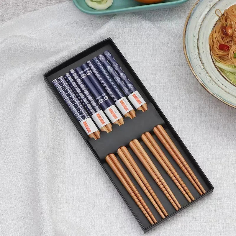 Set of five pairs of bamboo chopsticks with colourful Japanese lucky cat and elegant blue patterns.