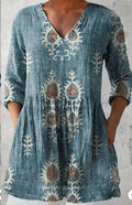 Women's loose-fitting dress with a blue wave print pattern, wide waist, and three-quarter length sleeves.