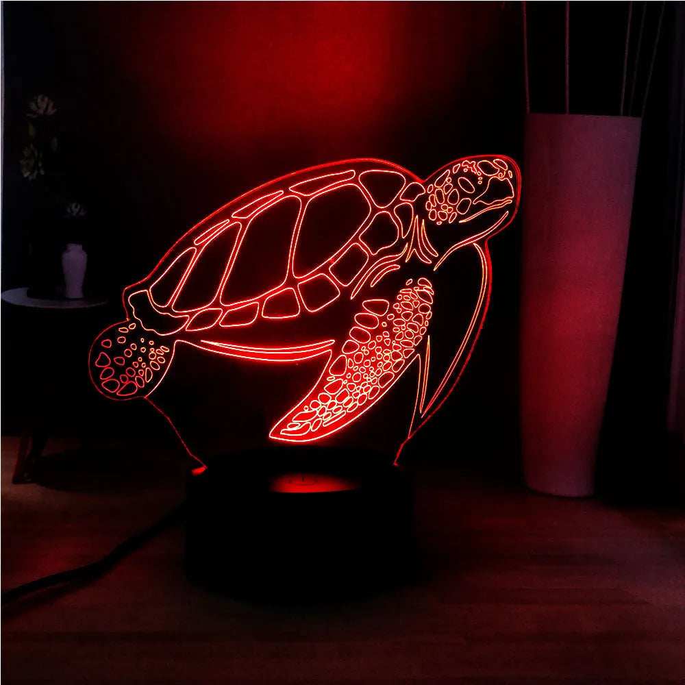3D clear acrylic turtle-shaped LED night light with multicolour glow on a dark surface.