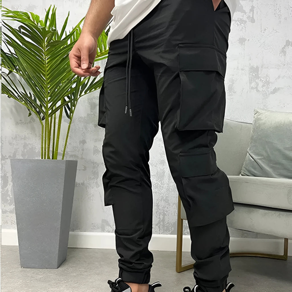 Men's stretch nylon ankle banded slacks in black, side view, plain colour design