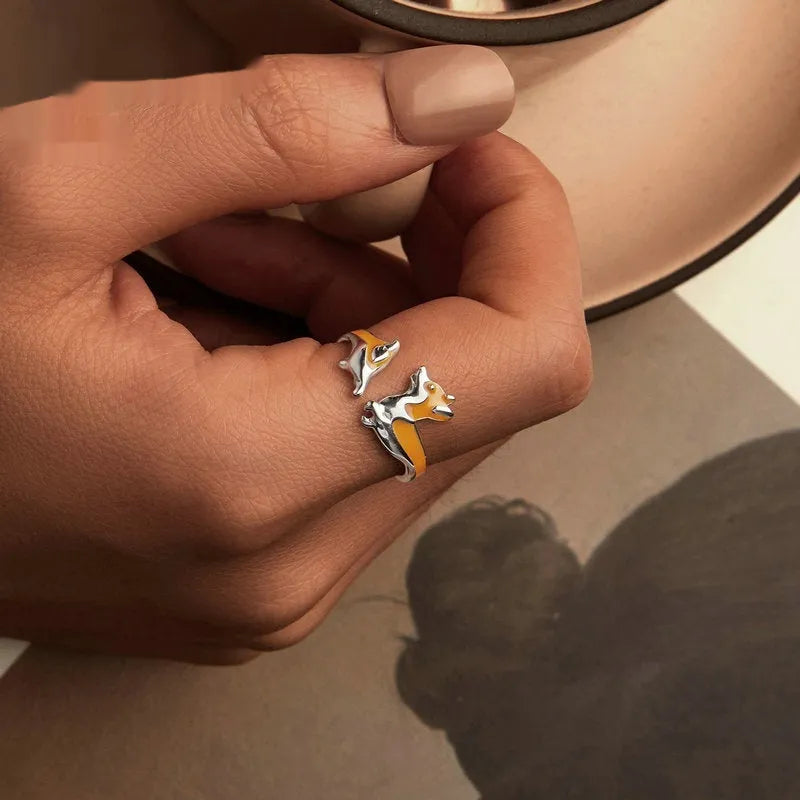 Silver-coloured adjustable ring featuring a raised cartoon corgi dog design, model SCR1014-E.