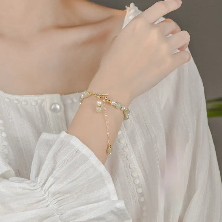 Women's Hetian jade bracelet with pearl pendant and electroplated gold alloy metal in Chinese style