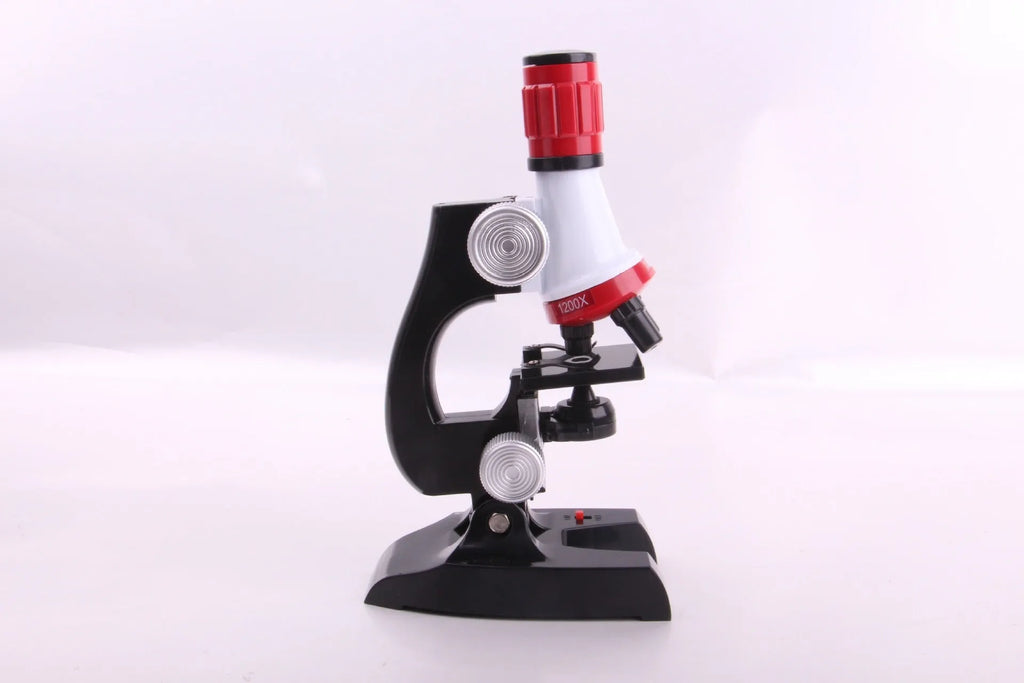 Child biological microscope with LED light, three objective lenses, and coarse focus knob on white background