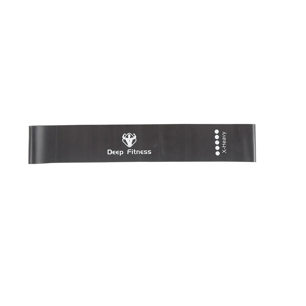 Yoga hip resistance band set in six colours from 0.4mm green to 1.2mm black laid flat on a surface