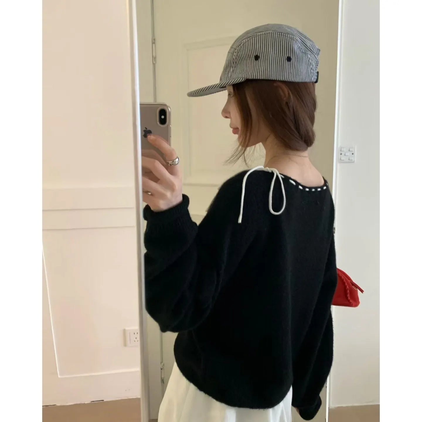 Grey loose-fitting women's knitwear pullover on a hanger.