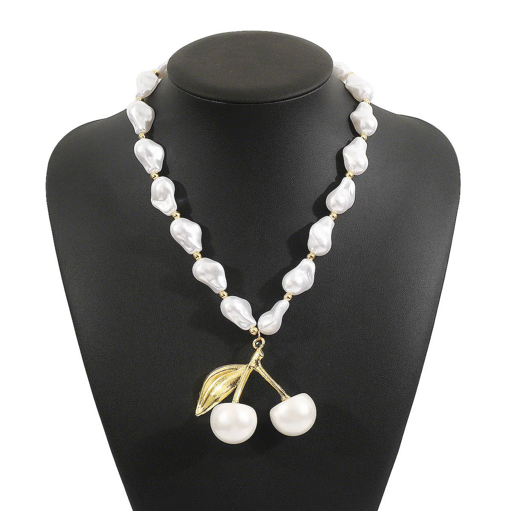Women's adjustable geometric fruit pendant necklace on a pearl chain in gold or white K.