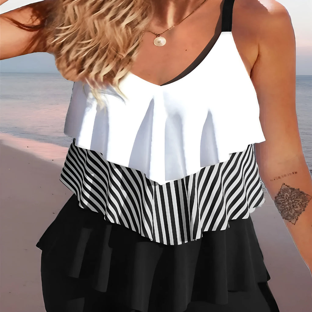 Women's sleeveless backless spaghetti-strap ruffle bikini swimsuit on a mannequin.
