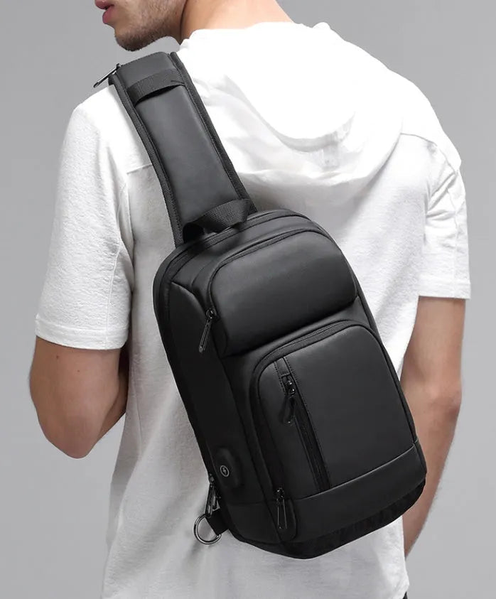 Black PVC outdoor shoulder bag with adjustable strap and internal laptop compartment