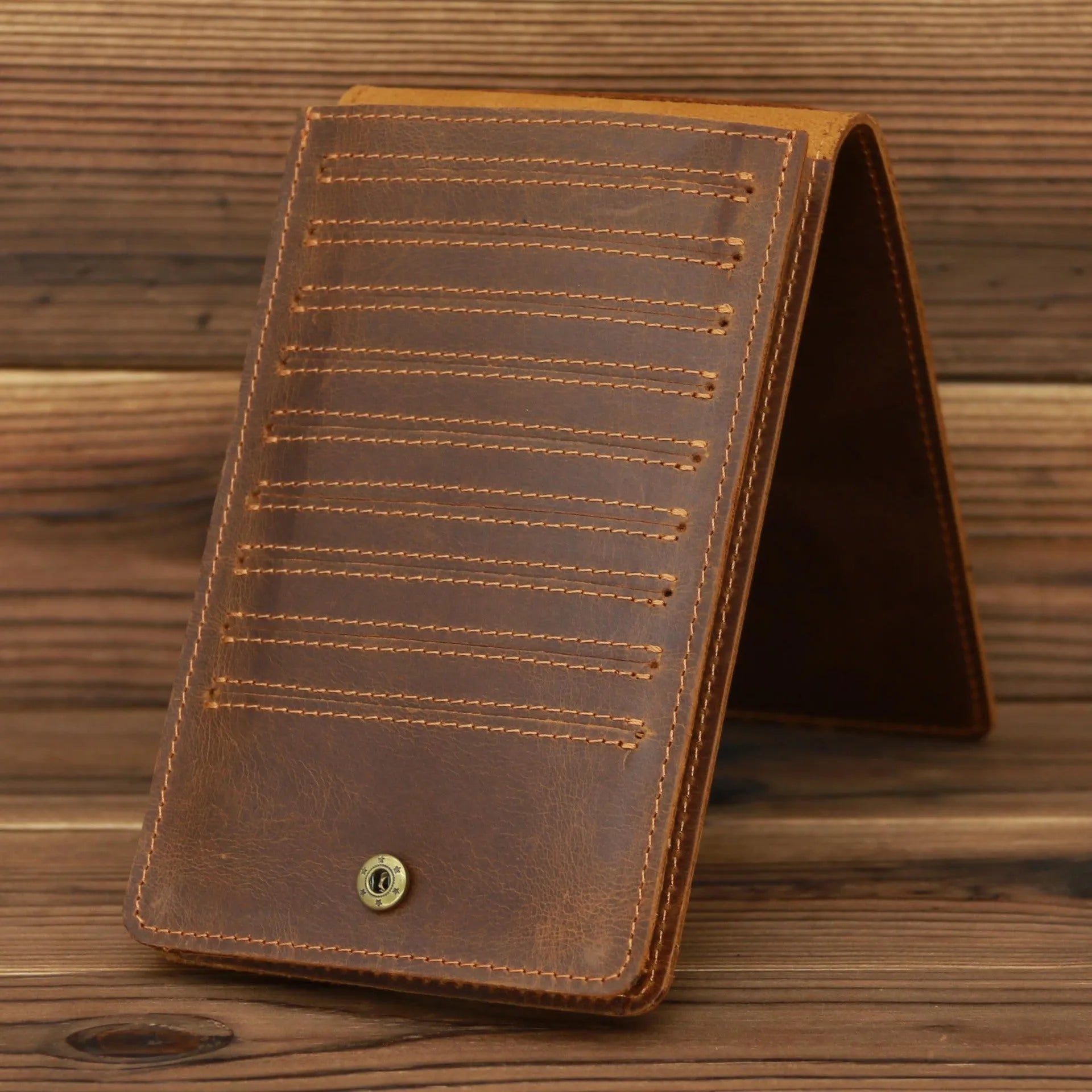 Slim black leather men's wallet open to show 18 card slots and a central mobile phone pocket.