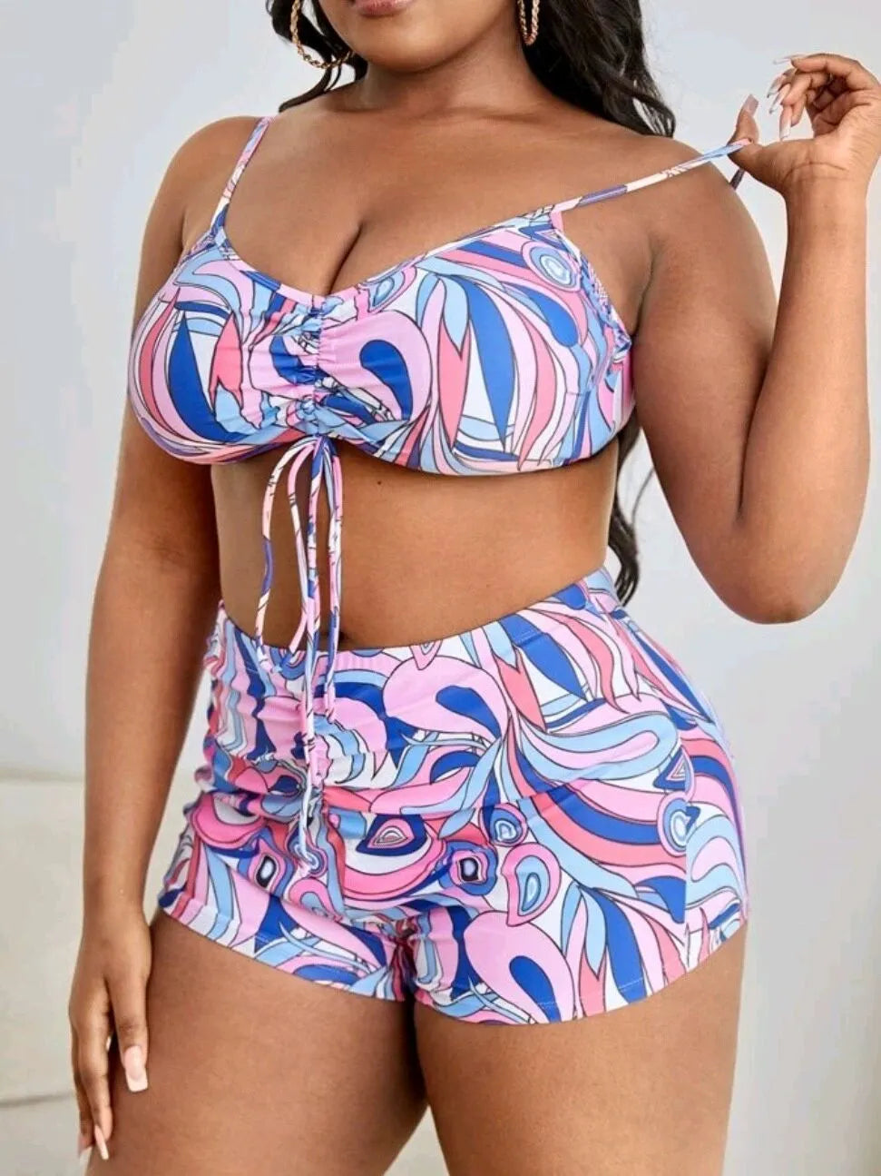 Women's floral print polyester bikini set with bra, briefs, and cardigan.