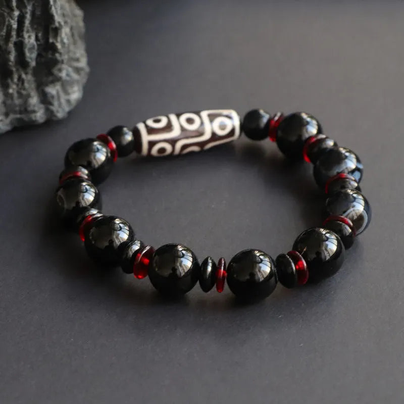Black agate dzi bead bracelet with 11mm geometric beads and hand-woven construction