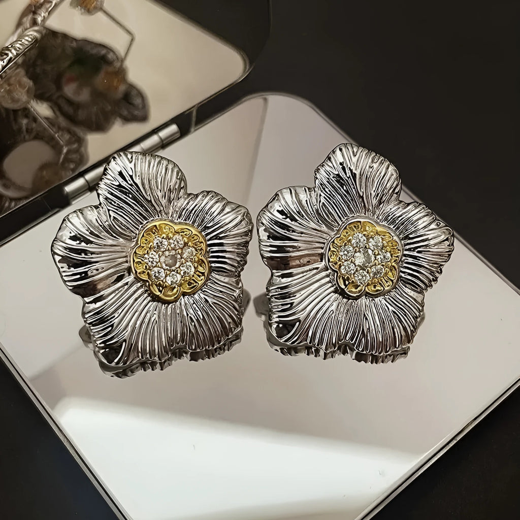 Copper stud earrings with textured gardenia flower design and two-tone electroplated finish.