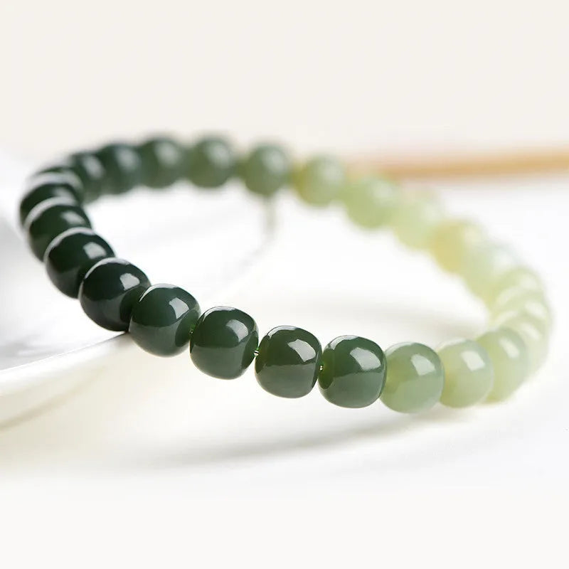 Natural Hetian jade water gradient bracelet with polished beads on a wrist.