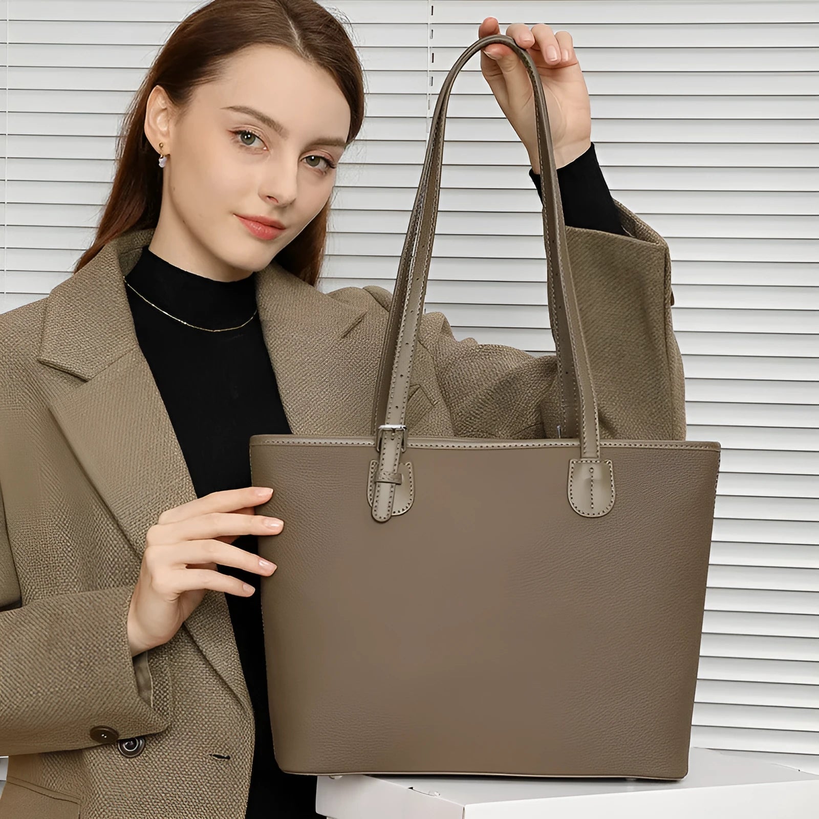 Women's genuine leather tote bag 30cm wide in black colour showing internal zipper compartments and retro styling